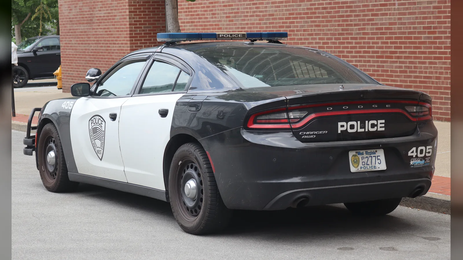 Black and white 2019 Dodge Charger Pursuit police car, rear three-quarter view