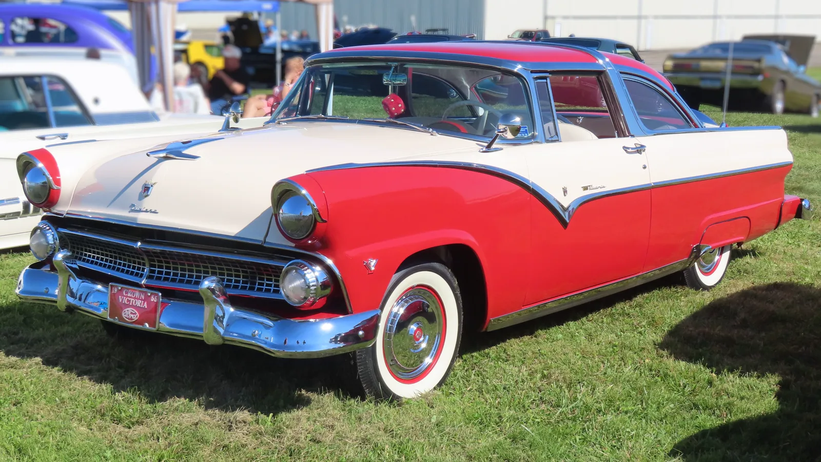 Red and white 1955 Ford Fairlane Crown Victoria, front three-quarter view, at a car show